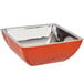 A Bon Chef orange triple wall square bowl with a silver rim.