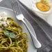 A plate of pasta with an Acopa Vernon stainless steel dinner fork on the side.