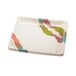 A white square melamine plate with colorful designs on it.