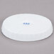 A white oval serving dish with fluted edges.