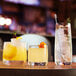 A table with three Chef & Sommelier Cabernet Rocks glasses filled with cocktails.