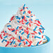 A cup of ice cream with Adourne red, white, and blue sprinkles.