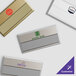 A group of rectangular Cawley customizable gold metal nametags.