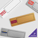 A group of rectangular white plastic nametags with black borders.