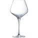 A close-up of a clear Chef & Sommelier wine glass with a long stem.