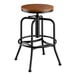 A Lancaster Table & Seating black metal bar stool with a wooden seat.