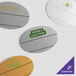 Four white oval Cawley nametags with green oval logos.