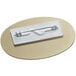 A gold metal oval nametag with a white plastic pin.