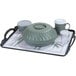 A Dinex low profile room service tray holding a green bowl and plastic cups with lids.