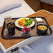 A Dinex Glasteel tray with a bowl of soup, a bowl of berries, and a mug of brown liquid on a table.