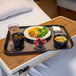 A Dinex Onyx fiberglass tray with a bowl of soup, berries, and a drink on it.