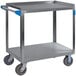 A Carlisle stainless steel utility cart with blue handles.