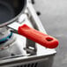 A red Choice silicone pan handle sleeve on a pan.