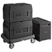 A stack of black Metro Mightylite pan carriers on a dolly.