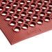 a red rubber mat with holes