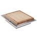 An Eastern Tabletop grey grain drop-in carving station tile with a wooden cutting board on a metal tray.