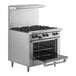 A U.S. Range stainless steel 6 burner range with an open oven door.