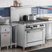 A U.S. Range commercial gas range with a standard oven on a counter in a commercial kitchen.