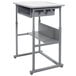 A grey Luxor student desk with a shelf.