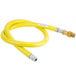 A yellow T&S gas appliance connector hose with a silver metal end.