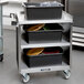 A Lakeside stainless steel utility cart with black laminate shelves.