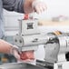 A man using a Backyard Pro meat grinder with a meat tenderizer attachment.