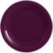 A close-up of a Fiesta® Mulberry round chop plate with a rim.