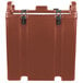 A brick red Cambro insulated soup carrier with a lid.