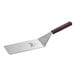 A Mercer Culinary Hell's Handle square edge turner with a brown wooden handle.