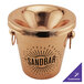 A customizable copper wine tasting spittoon on a table.