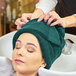 A woman with a Monarch Brands hunter green towel on her head.