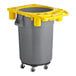 A grey and yellow trash can on wheels.