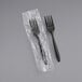 Two Choice black plastic forks individually wrapped in plastic.