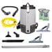 A ProTeam backpack vacuum cleaner with various tools.