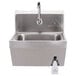 A stainless steel Advance Tabco hand sink with a faucet.