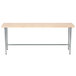 An Advance Tabco wood top work table with a galvanized metal base.