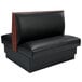 An American Tables & Seating black fully upholstered booth with wood accents.