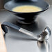 A Vollrath Jacob's Pride ladle with a bowl of soup.