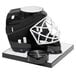 A black hockey helmet with a white hockey helmet and puck holder.