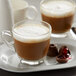A glass mug of UPOURIA Black Cherry hot chocolate with a cherry and chocolate on top.