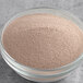 A bowl of UPOURIA Black Cherry hot chocolate mix powder.