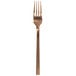 A Walco Rose Gold stainless steel table fork with a close up of the metal object.