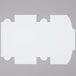 a white rectangular object with a black corner