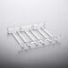 A clear plastic Franmara stemware hanger rack with rectangular slots on a white surface.