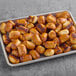 A tray of Dutch Country Foods soft pretzel nuggets on a table in a bakery display.