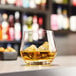 A Chef & Sommelier rocks glass filled with ice and whiskey.