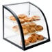 A Cal-Mil black iron bakery display case with bagels on it.