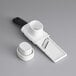 A white OXO Good Grips garlic slicer with a black handle.