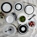 A table set with white Arcoroc opal glass plates and bowls.