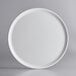 A GET Madison Avenue round white melamine display plate with a round rim.